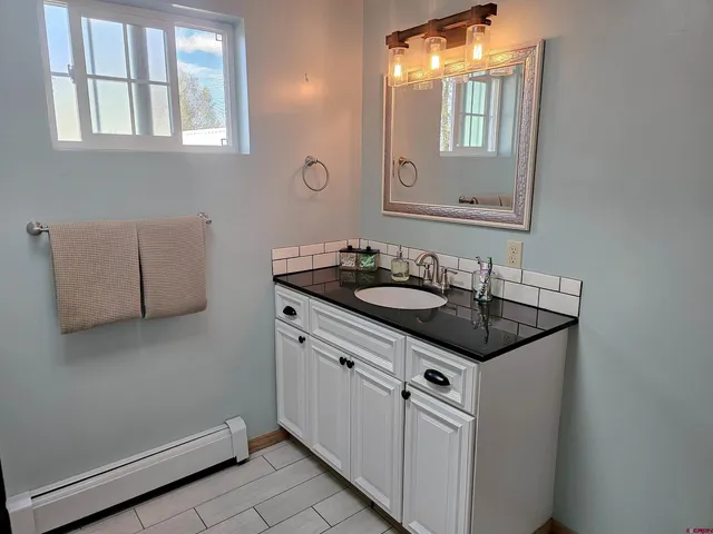 a bathroom with a sink and a mirror