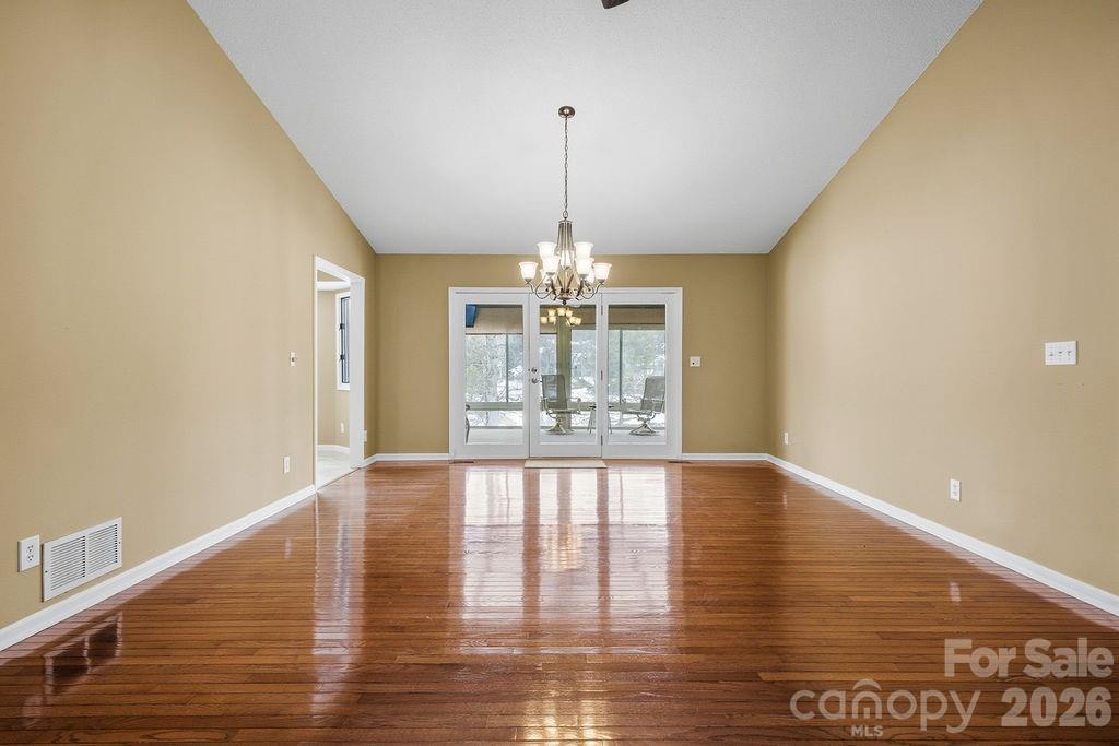 3100 Cove Loop Road Hendersonville, NC 28739 - Photo 12 of 43 a view of an empty room with window and wooden floor