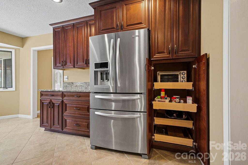 3100 Cove Loop Road Hendersonville, NC 28739 - Photo 14 of 43 a kitchen with stainless steel appliances granite countertop a refrigerator and a stove top oven