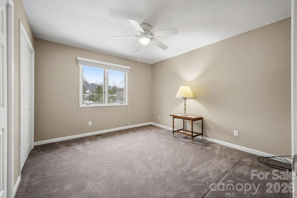 3100 Cove Loop Road Hendersonville, NC 28739 - Photo 26 of 43 a view of a livingroom with a ceiling fan and a window