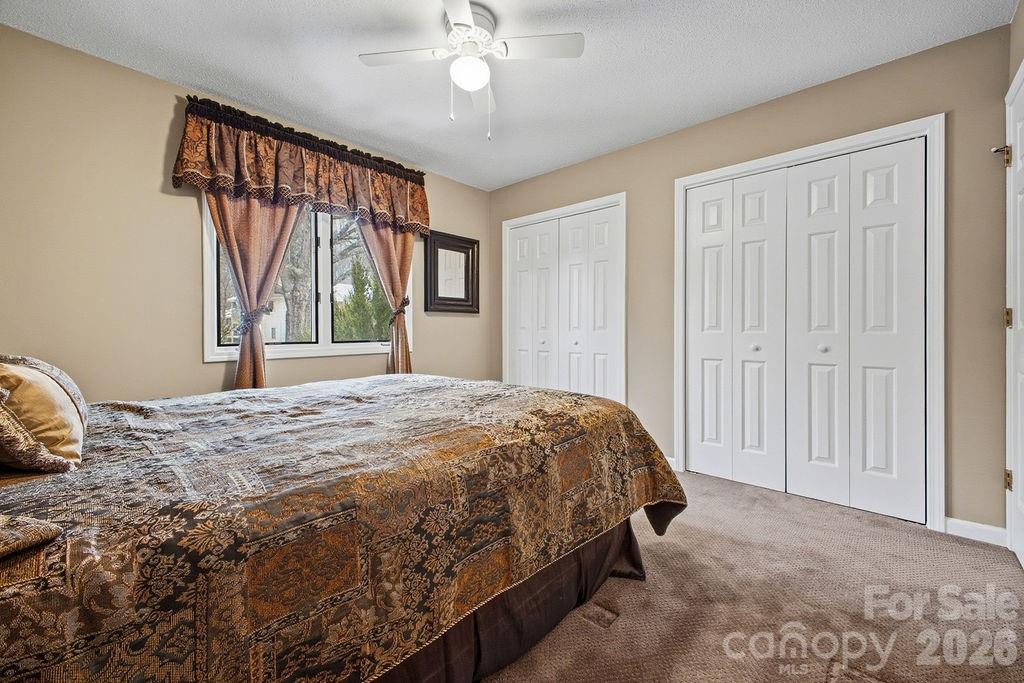 3100 Cove Loop Road Hendersonville, NC 28739 - Photo 29 of 43 a bedroom with a bed and a large window