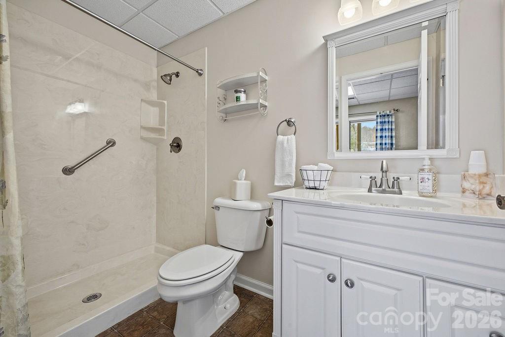 3100 Cove Loop Road Hendersonville, NC 28739 - Photo 34 of 43 a bathroom with a sink a toilet and shower