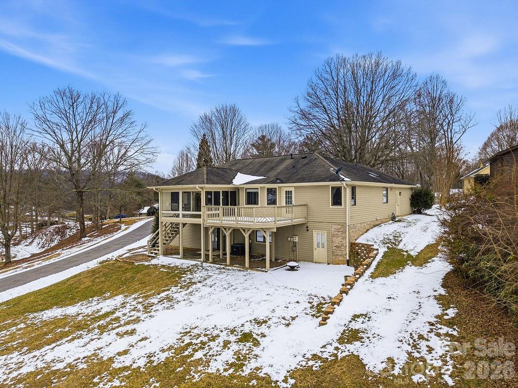 3100 Cove Loop Road Hendersonville, NC 28739 - Photo 6 of 43 a front view of a house with a yard covered with snow