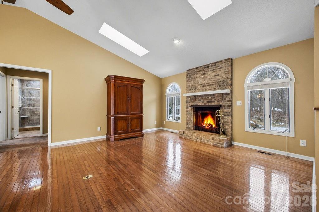 3100 Cove Loop Road Hendersonville, NC 28739 - Photo 8 of 43 a view of an empty room with a fireplace and a window