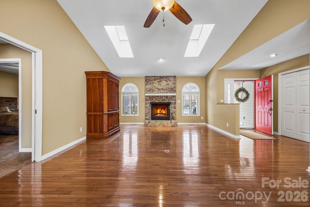 3100 Cove Loop Road Hendersonville, NC 28739 - Photo 10 of 43 a view of a livingroom with fireplace wooden floor and windows