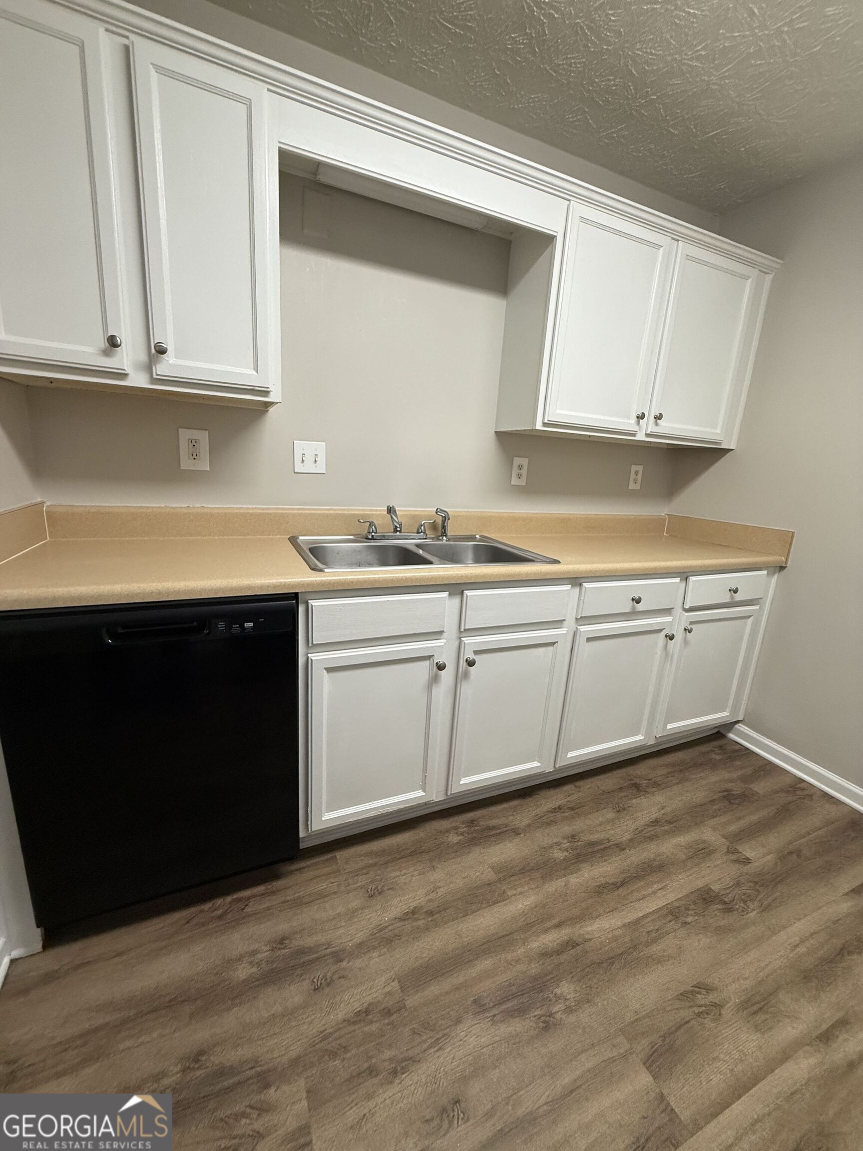 6132 Ruth Street Southwest Covington, GA 30014 - Photo 13 of 33 a kitchen with a sink cabinets and a window