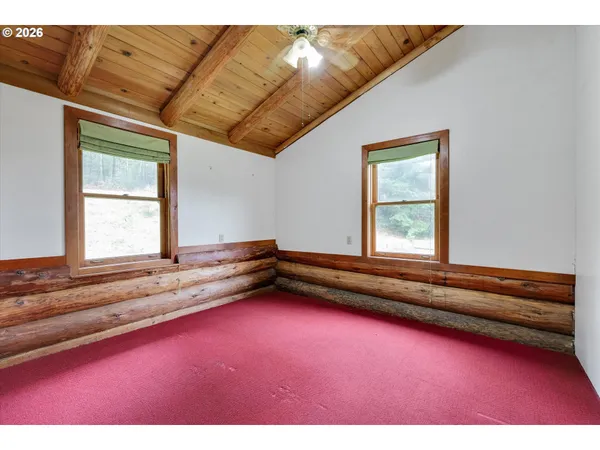 a view of empty room with ceiling fan