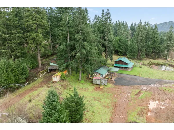 a backyard of a house with a yard and outdoor seating