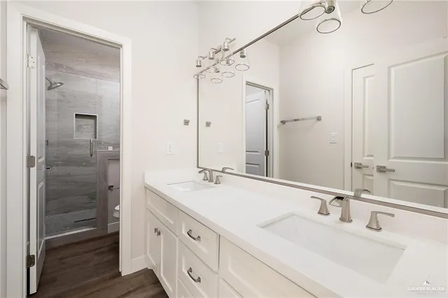 a bathroom with a double vanity sink mirror and double