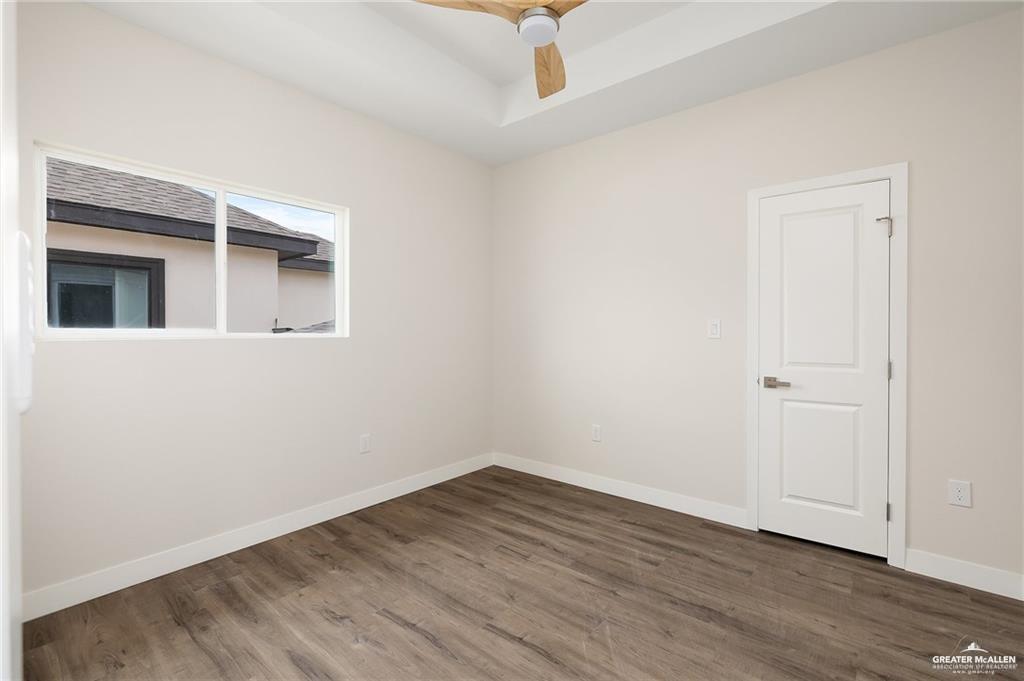 2508 East Solar Drive Mission, TX 78574 - Photo 12 of 13 an empty room with wooden floor and windows