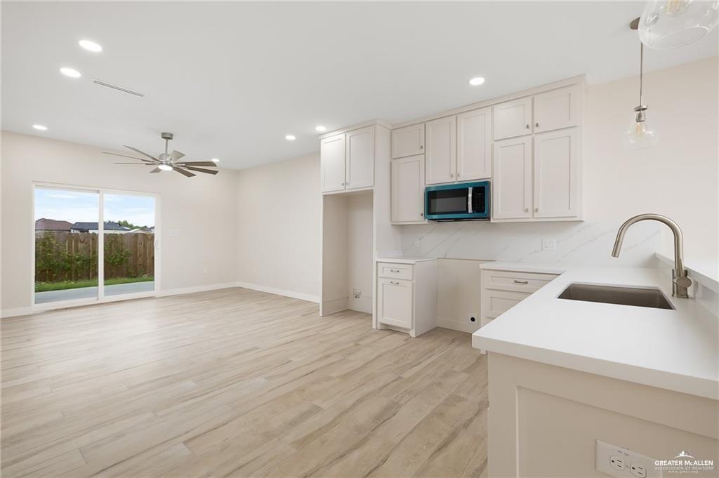 2508 East Solar Drive Mission, TX 78574 - Photo 4 of 13 a view of a kitchen with a sink and dishwasher with wooden floor