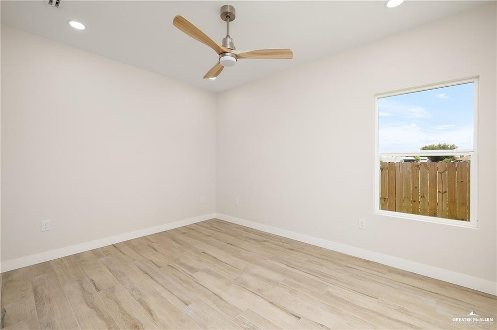 2508 East Solar Drive Mission, TX 78574 - Photo 7 of 13 an empty room with a window and ceiling fan