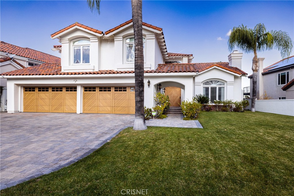 3626 Paseo Primario Calabasas, CA 91302 - Photo 2 of 41 a front view of a house with a yard and a garage