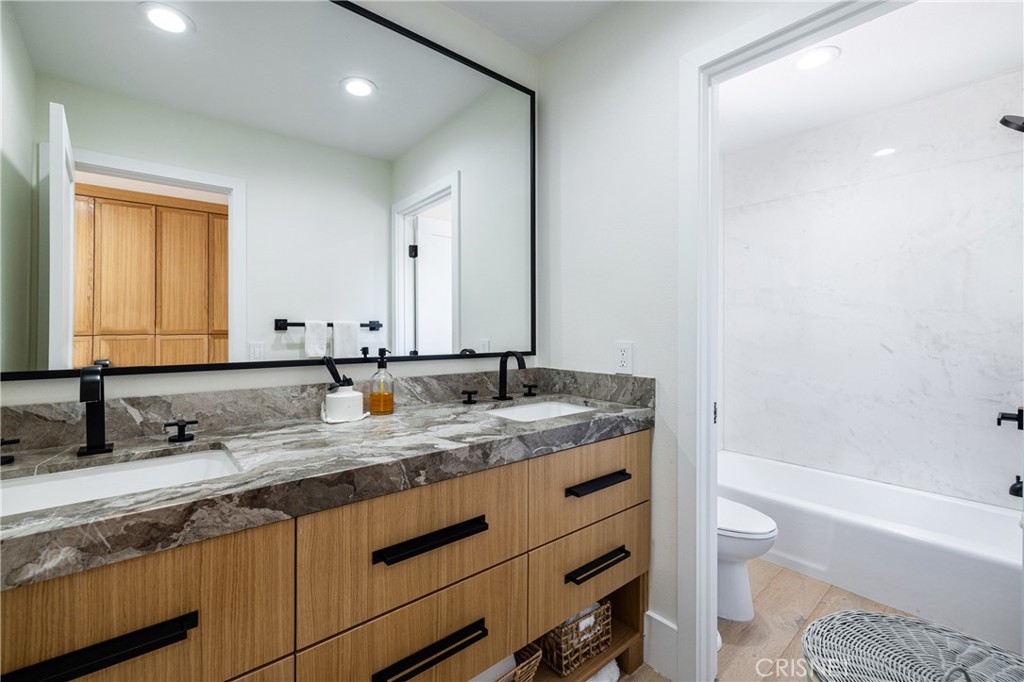 3626 Paseo Primario Calabasas, CA 91302 - Photo 26 of 41 a bathroom with a granite countertop sink a toilet and bathtub