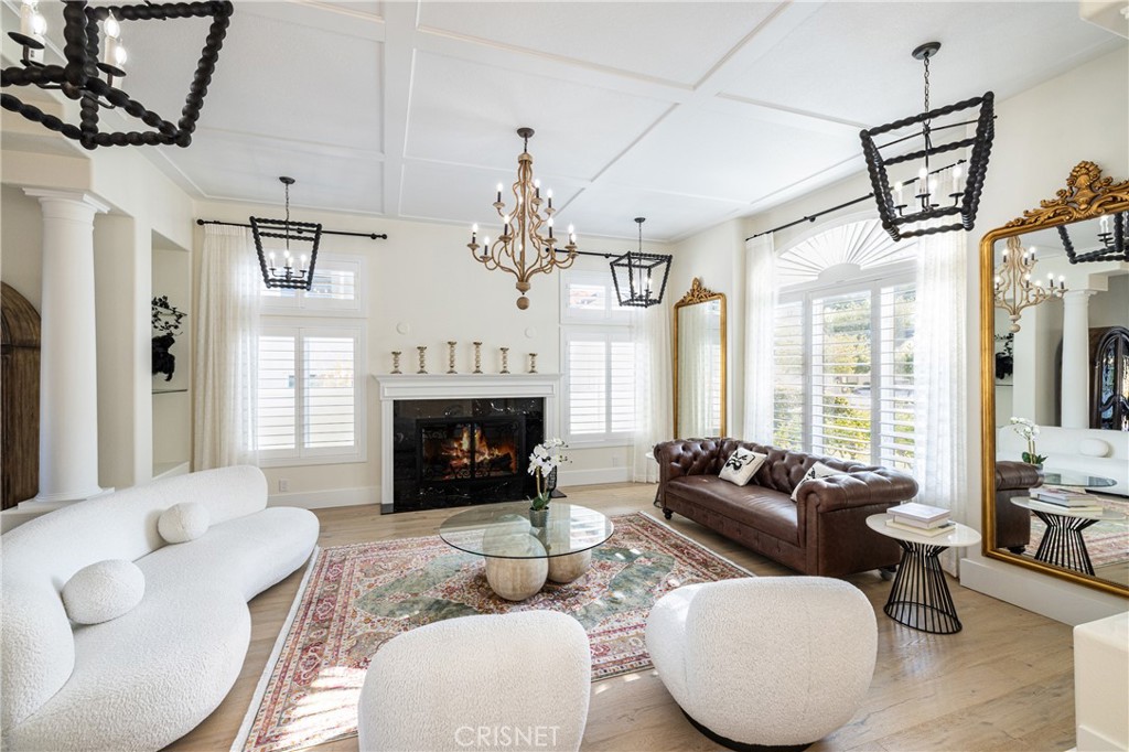 3626 Paseo Primario Calabasas, CA 91302 - Photo 6 of 41 a living room with furniture a chandelier and a fireplace