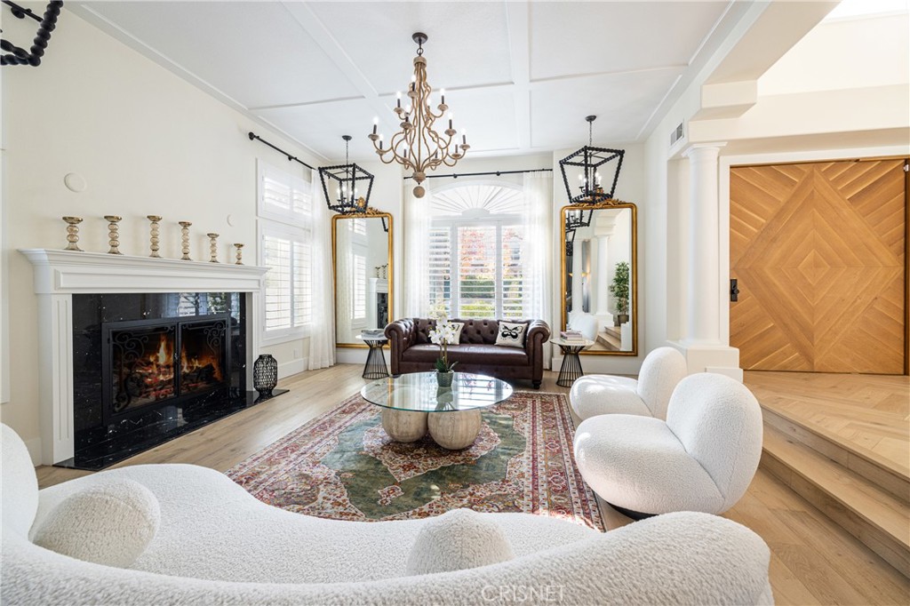 3626 Paseo Primario Calabasas, CA 91302 - Photo 7 of 41 a living room with furniture a chandelier and a fireplace