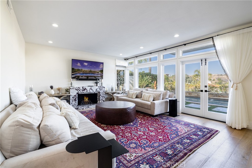3626 Paseo Primario Calabasas, CA 91302 - Photo 10 of 41 a living room with furniture fireplace and flat screen tv