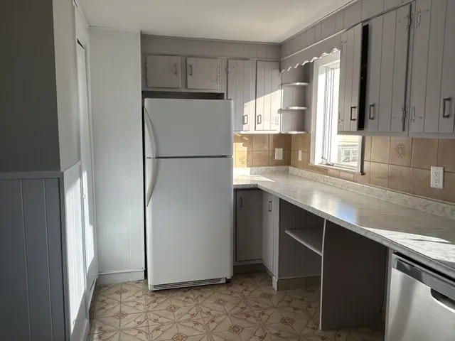 a kitchen with a refrigerator and a sink