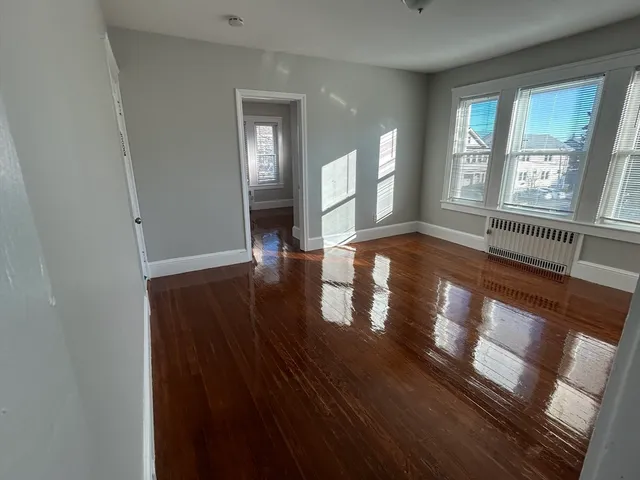a view of an entryway with wooden floor