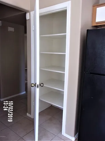 a view of a closet area with empty racks