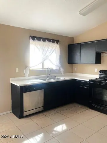 a kitchen with stainless steel appliances granite countertop a sink and a stove