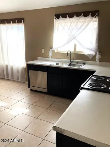 a kitchen with a sink a stove and a refrigerator
