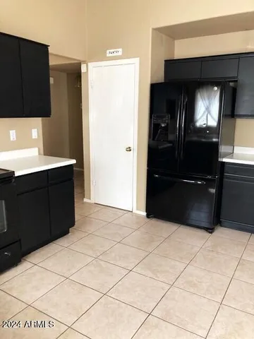 a kitchen with a refrigerator and cabinets