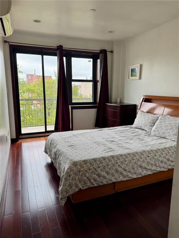 720 57th Street, Unit 4E Brooklyn, NY 11220 - Photo 3 of 4 a bedroom with a bed and a large window