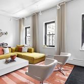 a living room with furniture a rug and a window