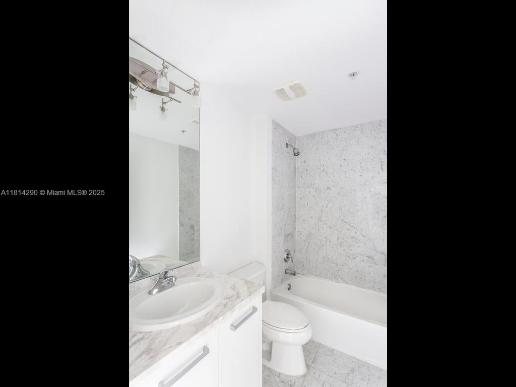 244 Biscayne Boulevard, Unit 2002 Miami, FL 33132 - Photo 12 of 21 a bathroom with a sink a toilet and bathtub