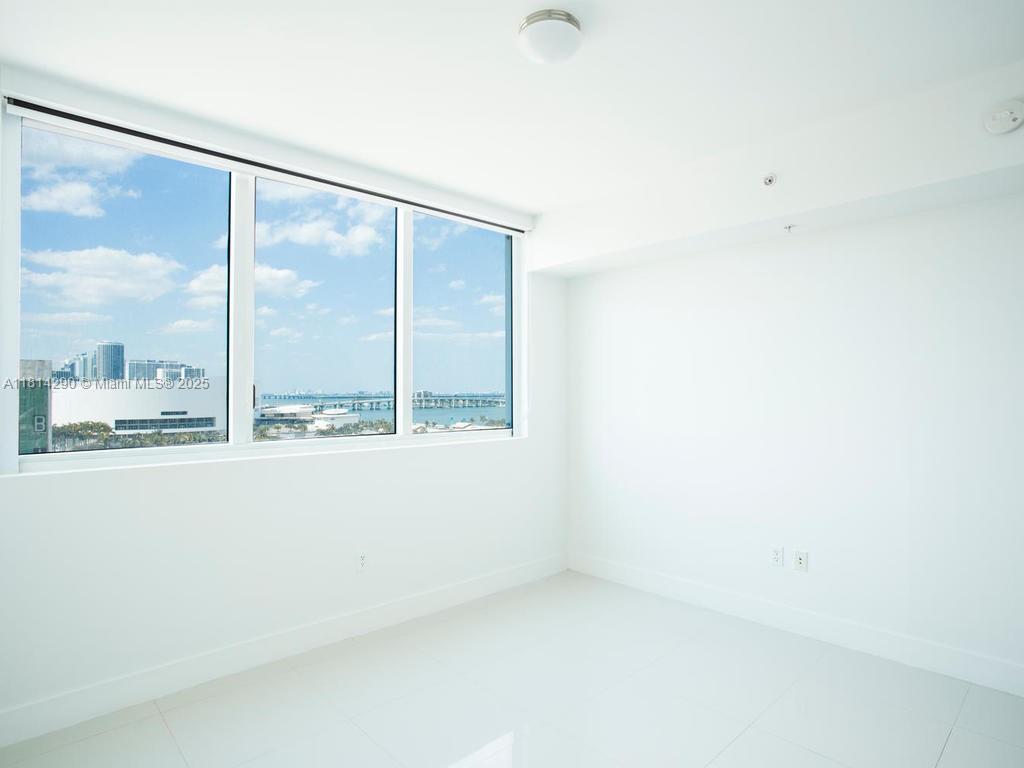 244 Biscayne Boulevard, Unit 2002 Miami, FL 33132 - Photo 13 of 21 a view of lot of windows in an empty room