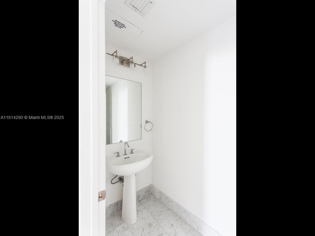 244 Biscayne Boulevard, Unit 2002 Miami, FL 33132 - Photo 15 of 21 a view of a bathroom with a sink and mirror