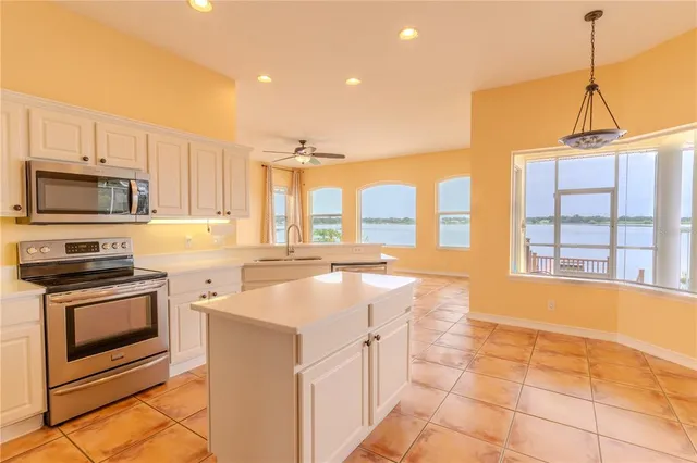 a large kitchen with stainless steel appliances lots of counter space and wooden floor