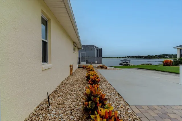 a view of a white house with a small yard and a large window