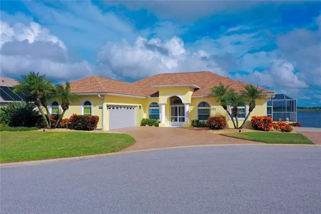 an aerial view of a house with outdoor space and lake view