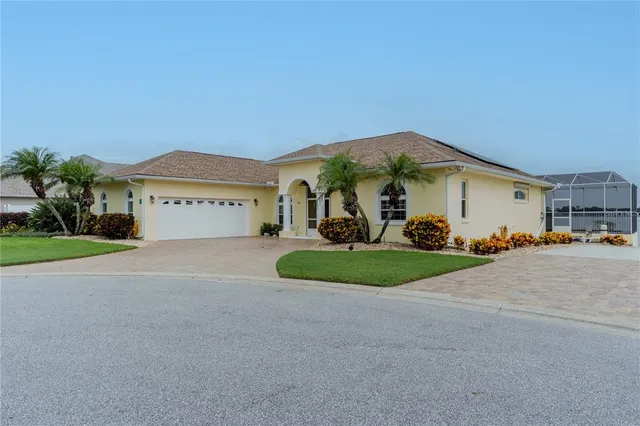 an aerial view of a house with a garden and swimming pool