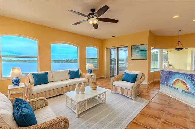 a living room with furniture ceiling fan and a rug