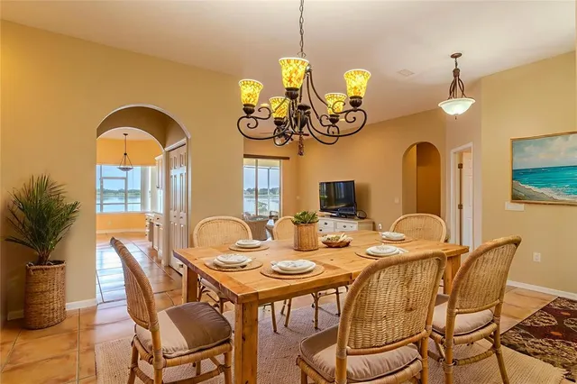 a bedroom with a bed and a flat tv screen on dresser