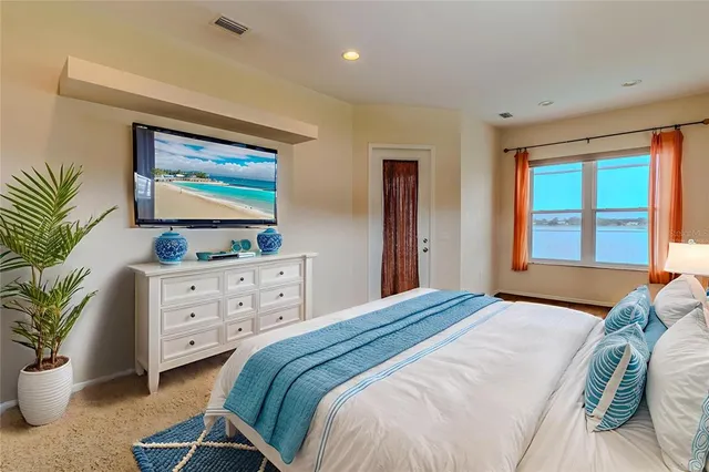 a bedroom with a bed and a painting on the wall