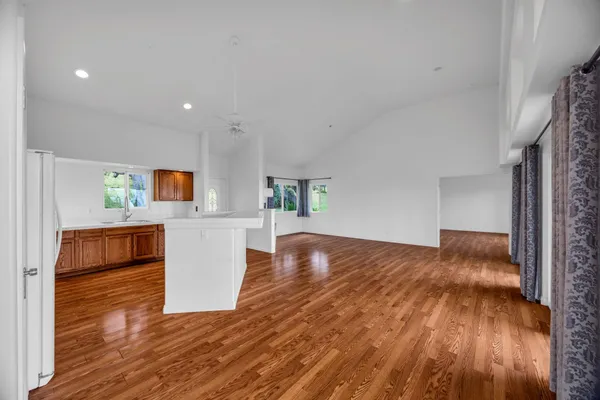 a view of kitchen and hall with wooden floor