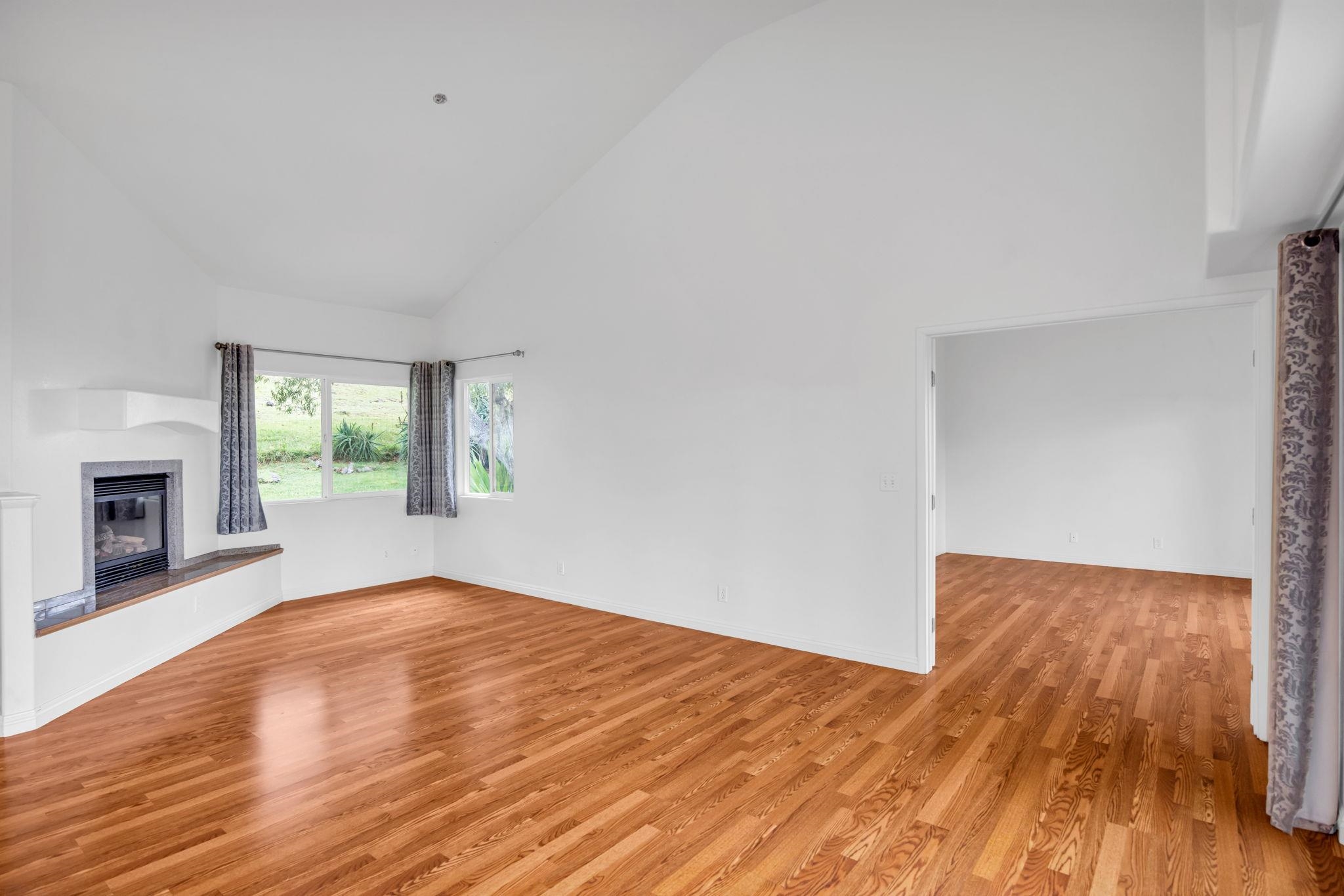 115 Alae Road Kula, HI 96790 - Photo 18 of 50 a view of empty room with wooden floor and fireplace