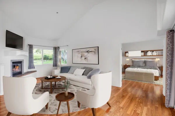 a living room with furniture and a wooden floor