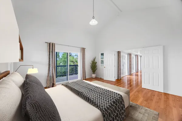 a bedroom with a large bed and a window