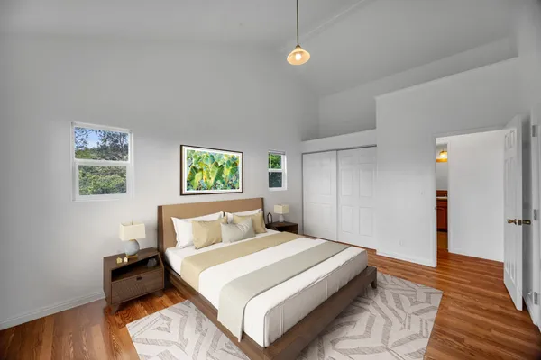 a bedroom with a bed and wooden floor