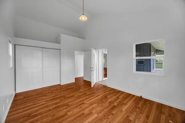 a bedroom with a bed and a painting on the wall