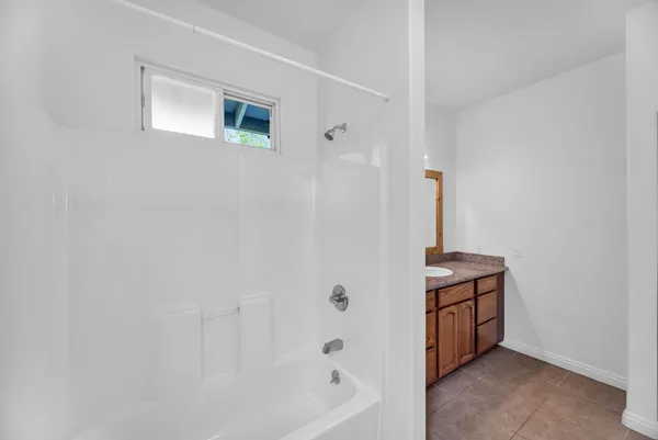 a bathroom with a bathtub and shower