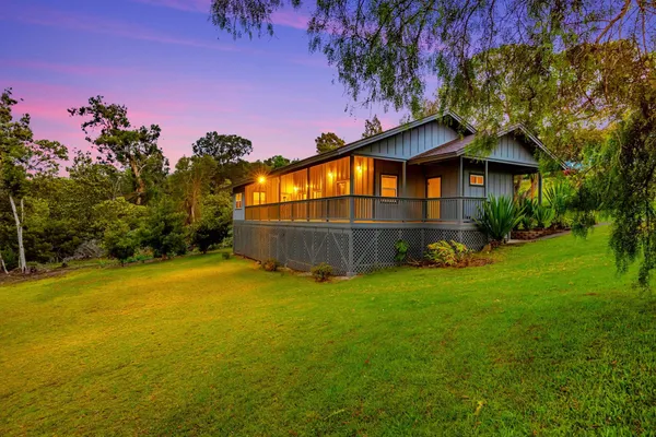 a view of a house with a backyard