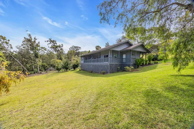 a backyard of a house with table and chairs