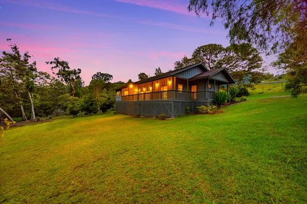 a front view of a house with a big yard
