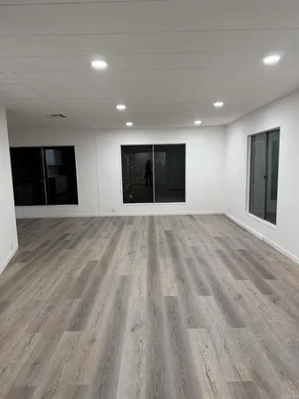 a view of empty room with wooden floor